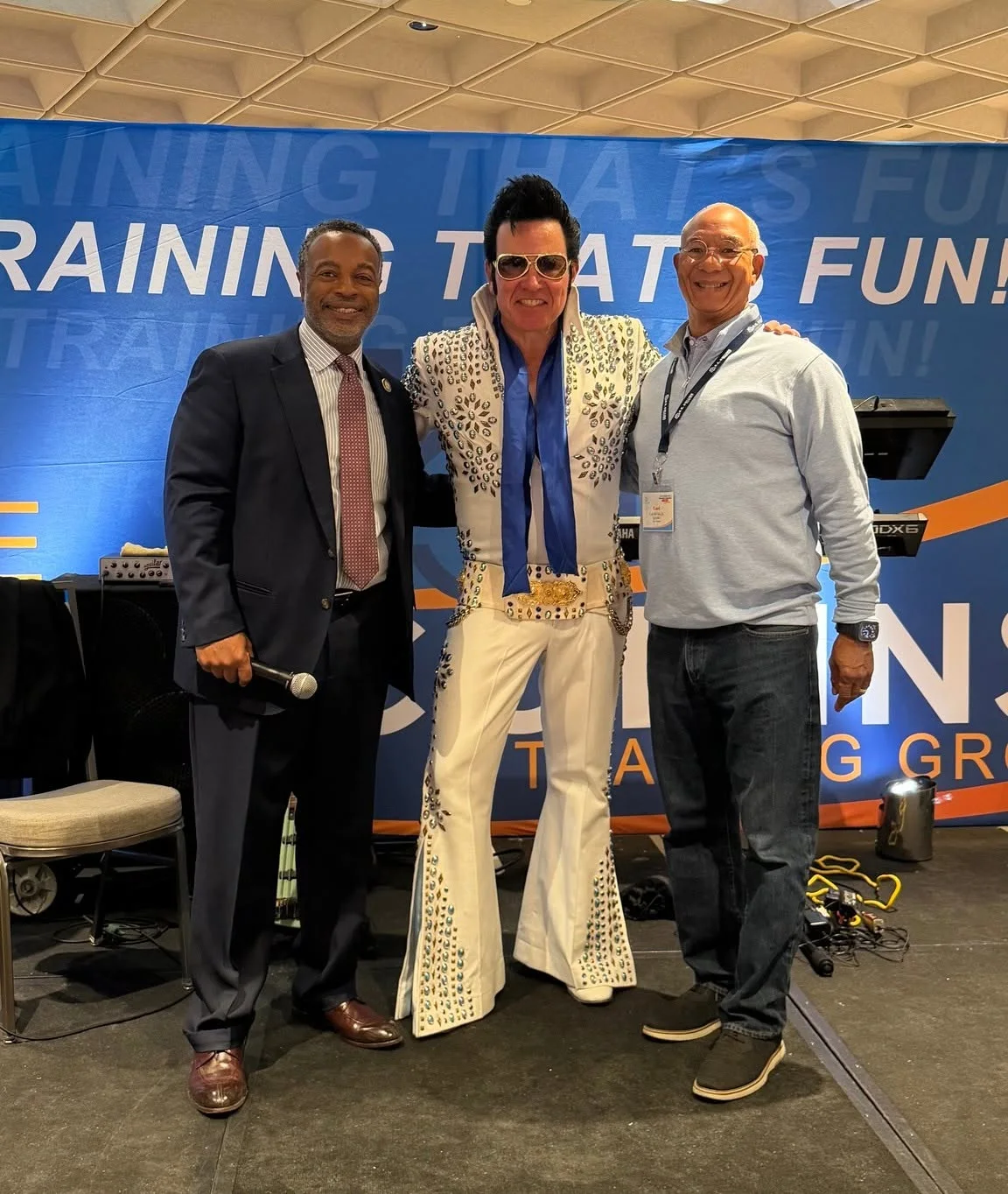 Bobby Collins posing with two attendees at a B.R. Collins event